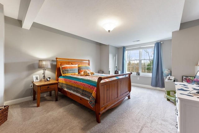 bedroom with baseboards, visible vents, and light carpet