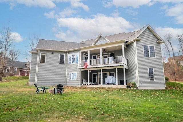 back of property featuring a lawn, a patio, a ceiling fan, and a balcony