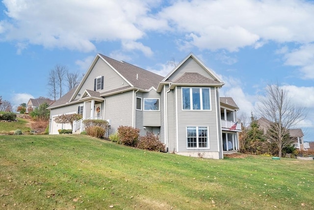 view of front of property featuring a front lawn and a balcony