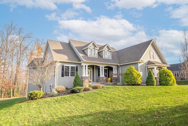 cape cod-style house featuring roof with shingles, a porch, and a front yard