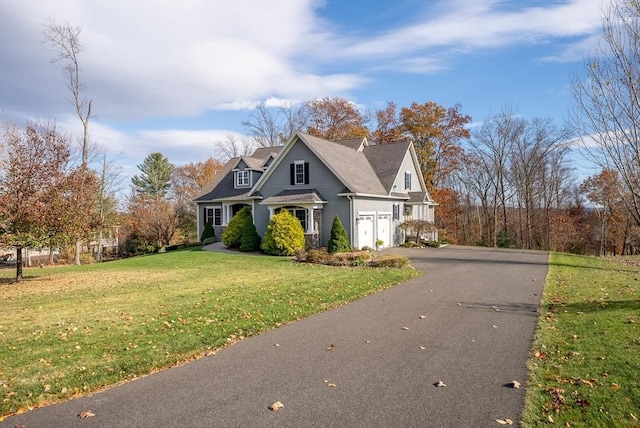 view of front facade with a front lawn and aphalt driveway