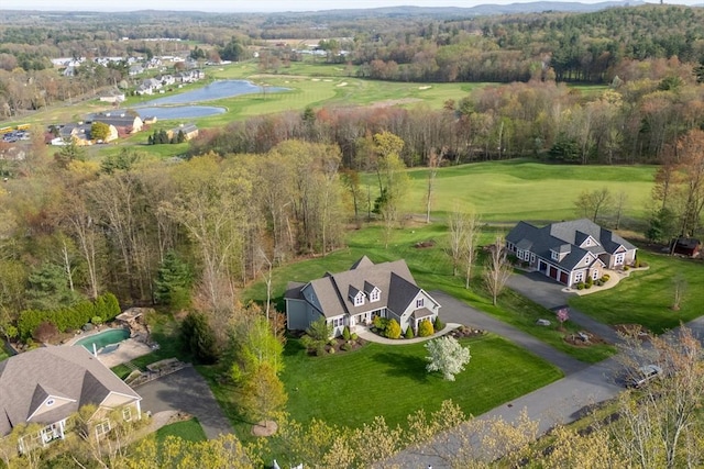 birds eye view of property with a water view and view of golf course
