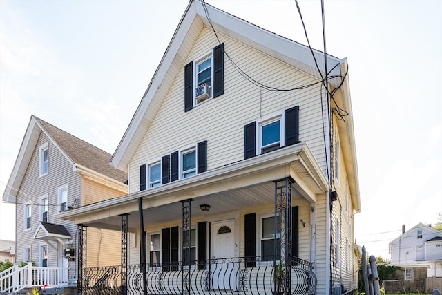 view of front facade with cooling unit and a porch