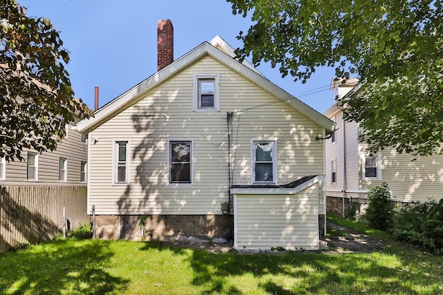 rear view of house with a lawn