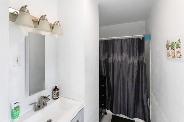 bathroom featuring curtained shower and vanity