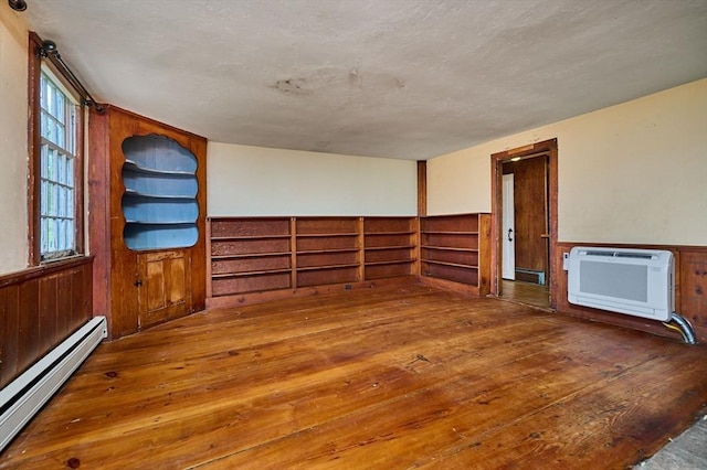 40 Whately Glen Rd, Conway, MA 01341 - unfurnished room with a baseboard heating unit, heating unit, hardwood / wood-style floors, wainscoting, and wood walls
