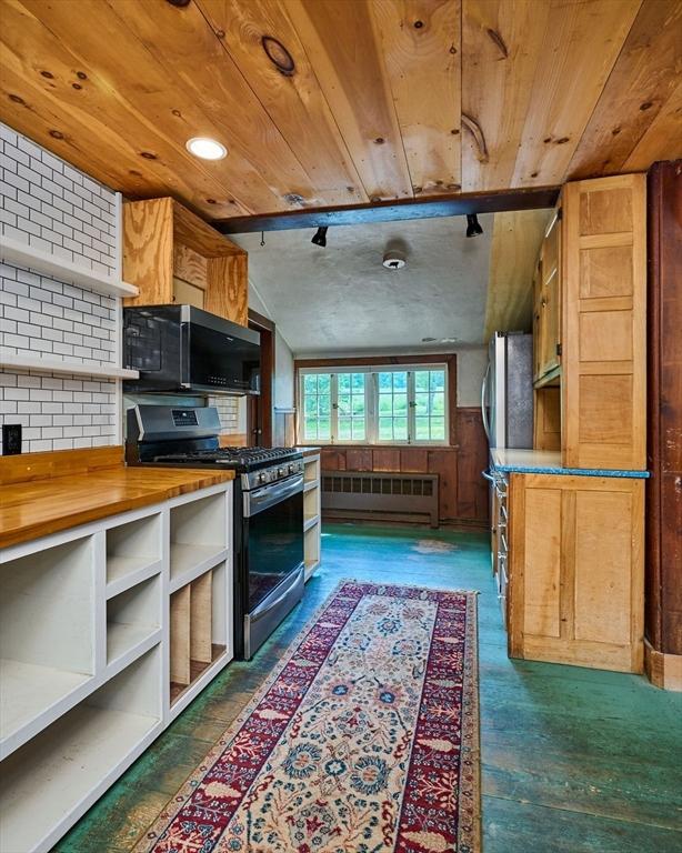 40 Whately Glen Rd, Conway, MA 01341 - kitchen with stainless steel appliances, wood ceiling, butcher block counters, and open shelves