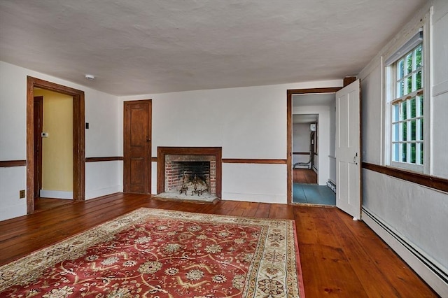 40 Whately Glen Rd, Conway, MA 01341 - unfurnished living room with a baseboard radiator, hardwood / wood-style floors, and a fireplace