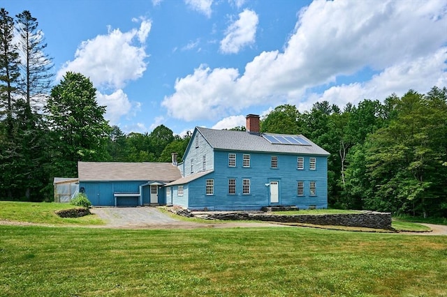40 Whately Glen Rd, Conway, MA 01341 - back of house with a chimney, a lawn, an outbuilding, and roof mounted solar panels