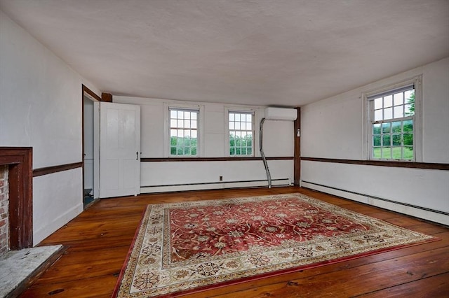 40 Whately Glen Rd, Conway, MA 01341 - empty room with a wall mounted air conditioner, baseboard heating, plenty of natural light, and wood-type flooring