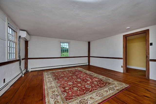 40 Whately Glen Rd, Conway, MA 01341 - spare room featuring a baseboard radiator, wood-type flooring, and a wall mounted AC