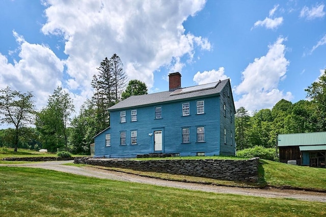 40 Whately Glen Rd, Conway, MA 01341 - back of house with a chimney, a lawn, and solar panels
