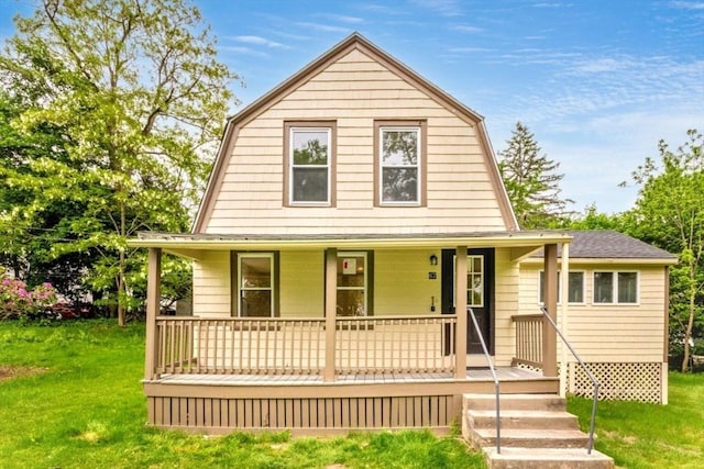 67 Thatcher St, Brockton, MA 02302 - colonial inspired home featuring a gambrel roof, a porch, and a front lawn