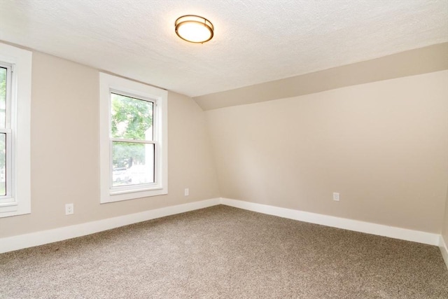 67 Thatcher St, Brockton, MA 02302 - additional living space featuring carpet flooring, vaulted ceiling, a textured ceiling, and baseboards