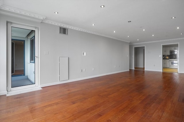 unfurnished living room with hardwood / wood-style flooring and crown molding