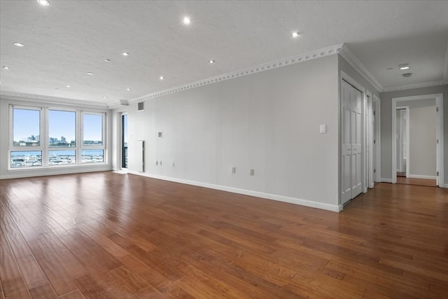 unfurnished living room featuring ornamental molding, a textured ceiling, and hardwood / wood-style floors