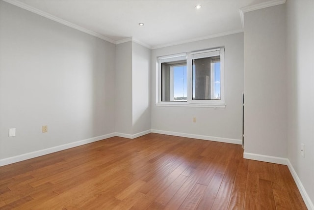 spare room featuring ornamental molding and hardwood / wood-style floors