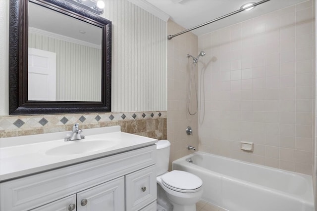 full bathroom with ornamental molding, vanity, toilet, and tiled shower / bath