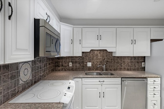 kitchen featuring decorative backsplash, white cabinetry, sink, and stainless steel appliances