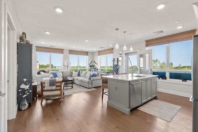 130 Broad Reach Unit 409, Weymouth, MA 02191 - kitchen with a sink, stainless steel dishwasher, dark wood finished floors, and recessed lighting