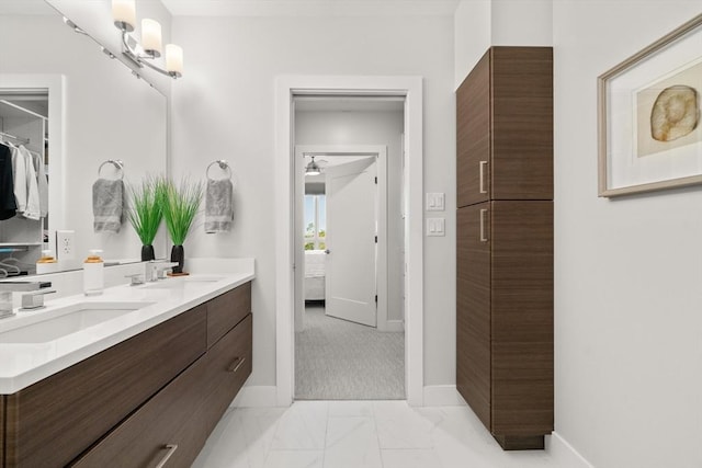 130 Broad Reach Unit 409, Weymouth, MA 02191 - bathroom featuring double vanity, baseboards, marble finish flooring, and a ceiling fan
