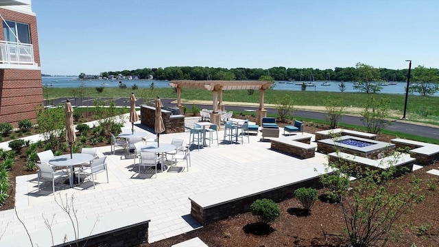 130 Broad Reach Unit 409, Weymouth, MA 02191 - view of patio featuring a fire pit, outdoor dining area, and a water view