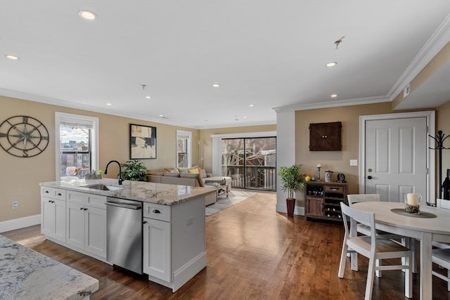 kitchen featuring a healthy amount of sunlight, stainless steel dishwasher, dark wood-style flooring, and a sink