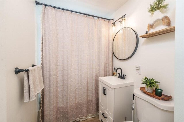 bathroom featuring vanity and toilet