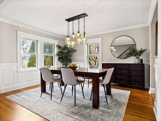 dining room featuring a wealth of natural light, wood-type flooring, and crown molding