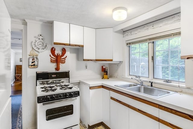 127 Short Beach Rd, Barnstable, MA 02632 - kitchen with white range with gas cooktop, a sink, white cabinetry, and light countertops