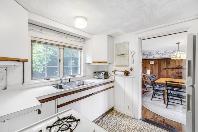 127 Short Beach Rd, Barnstable, MA 02632 - kitchen featuring white cabinets, freestanding refrigerator, a sink, and light countertops