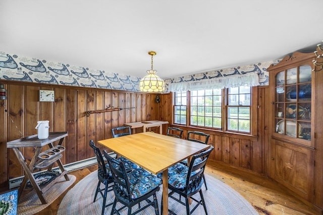 127 Short Beach Rd, Barnstable, MA 02632 - dining area with light wood-style floors and wooden walls