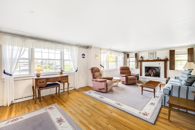 127 Short Beach Rd, Barnstable, MA 02632 - living room with wood finished floors, healthy amount of natural light, and a baseboard heating unit