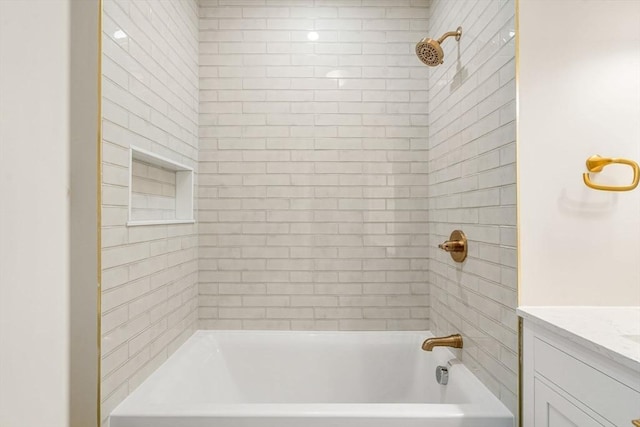 bathroom featuring vanity and tiled shower / bath combo