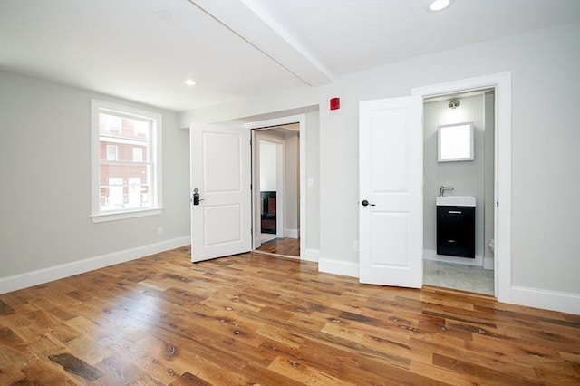 89 Morris St, Boston, MA 02128 - unfurnished bedroom with wood finished floors, recessed lighting, and ensuite bath