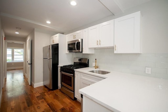 89 Morris St, Boston, MA 02128 - kitchen with stainless steel appliances, backsplash, white cabinetry, and recessed lighting