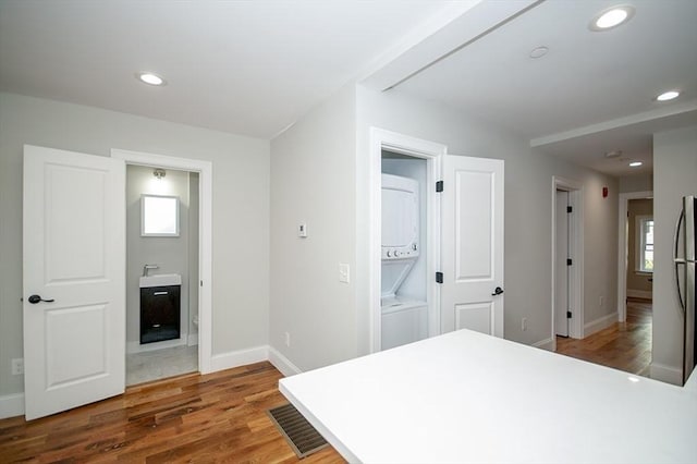 89 Morris St, Boston, MA 02128 - bedroom featuring stacked washer / drying machine, ensuite bath, wood finished floors, recessed lighting, and freestanding refrigerator
