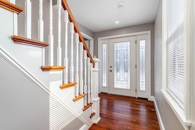 entrance foyer with dark hardwood / wood-style floors and plenty of natural light