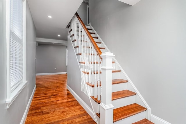 stairs featuring hardwood / wood-style floors