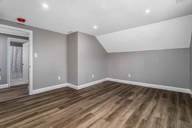 bonus room with dark hardwood / wood-style floors and lofted ceiling