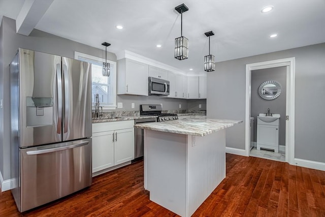 kitchen featuring white cabinetry, a center island, dark hardwood / wood-style floors, and appliances with stainless steel finishes