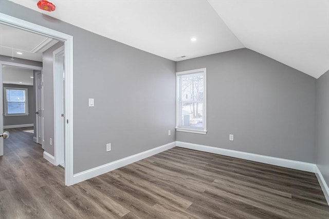 bonus room featuring dark wood-type flooring and lofted ceiling