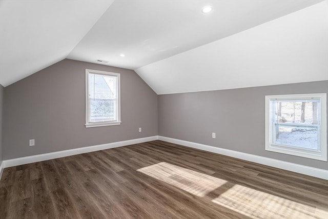 additional living space with dark hardwood / wood-style floors and lofted ceiling