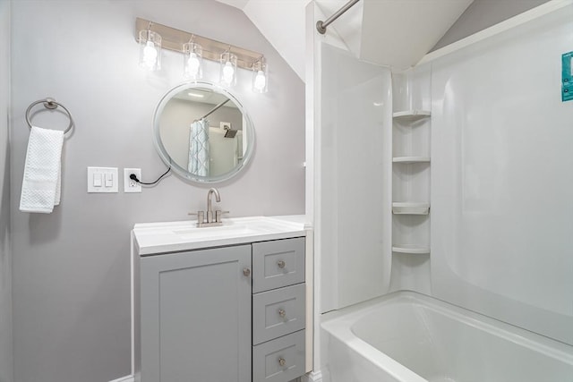 bathroom featuring vanity, shower / bath combination, and vaulted ceiling