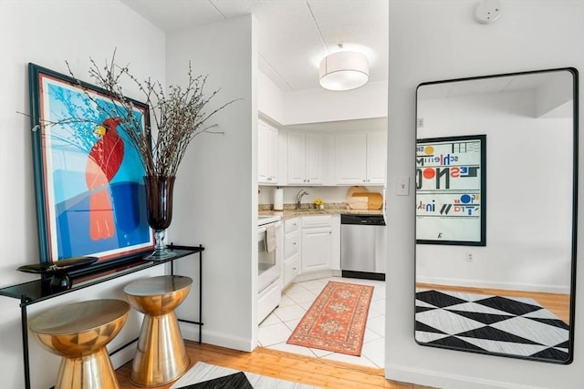 135 Pleasant St Unit 403, Brookline, MA 02446 - kitchen with dishwasher, white range with electric stovetop, white cabinetry, and light wood-type flooring