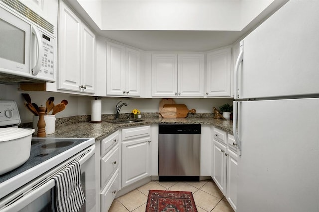 135 Pleasant St Unit 403, Brookline, MA 02446 - kitchen featuring white appliances, light tile patterned floors, and white cabinetry