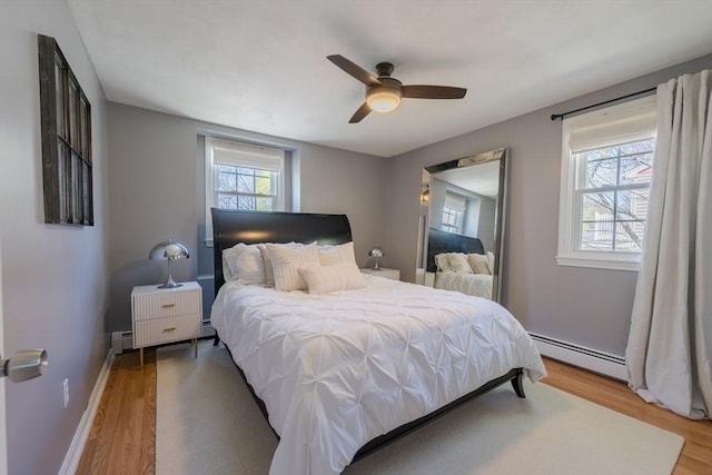 37 Hillcrest Ave, Methuen, MA 01844 - bedroom featuring baseboard heating, wood finished floors, ceiling fan, a baseboard heating unit, and baseboards
