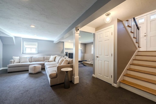37 Hillcrest Ave, Methuen, MA 01844 - living room featuring dark colored carpet, stairs, a fireplace, baseboards, and a textured ceiling