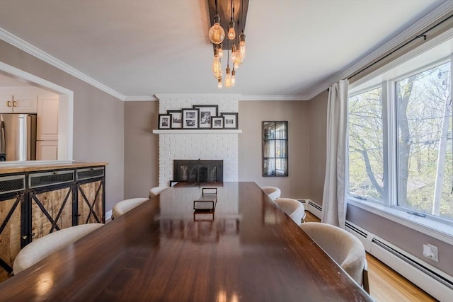 37 Hillcrest Ave, Methuen, MA 01844 - dining room with healthy amount of natural light, a baseboard heating unit, a brick fireplace, a chandelier, and ornamental molding