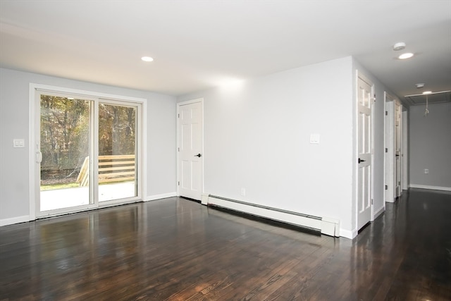 unfurnished room with dark hardwood / wood-style floors and baseboard heating